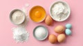 Ingredients for baking displayed on a pink surface with bowls of flour, sugar, eggs, and other essentials Royalty Free Stock Photo