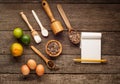 Ingredients for baking - flour, brown sugar, lime, allspice, wooden spoon, rolling pin, eggs. Top view with blank paper