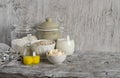 Ingredients for baking - flour, milk, butter, eggs on a light wooden table. Free space for text.