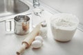 Ingredients for baking fresh bread and cake. Flour, eggs, beater, rolling pin, salt, a glass of water Royalty Free Stock Photo