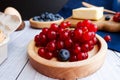 Ingredients for baking lie on a light wooden background with a blue kitchen towel. flour, eggs, butter, berries and wooden Royalty Free Stock Photo