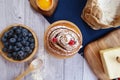 Ingredients for baking lie on a light wooden background with a blue kitchen towel. flour, eggs, butter, berries and wooden Royalty Free Stock Photo