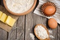 Ingredients for baking - milk, butter, eggs and flour. Rustic background.