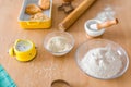 Ingredients for baking - rolling pin, flour in bowls, sugar, vanilla, molds and ceramic forms for baking, green towel