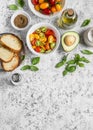 Ingredients for bruschetta - tomatoes, avocado, basil, olive oil, bread. On a light background