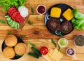 Ingredients for burger on wooden background. Top view Royalty Free Stock Photo