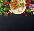 Ingredients for burritos wraps with beef and vegetables on black background.