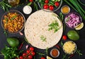 Ingredients for burritos wraps with beef and vegetables on black background. Royalty Free Stock Photo