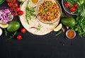 Ingredients for burritos wraps with beef and vegetables on black background. Royalty Free Stock Photo