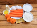 The ingredients for carrot cake on a wooden table
