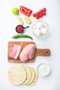 Ingredients for chicken tacos, , tomatoes, corn, egg, pepper,lime chicken meat and tortillas over white textured background top Royalty Free Stock Photo