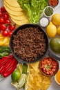 Ingredients for Chili con carne in frying iron pan on white wooden table Royalty Free Stock Photo