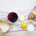 Ingredients for cooking berry pie on a white wooden background, overhead view. Flat lay, top view, from above. Copy space Royalty Free Stock Photo