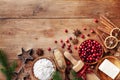 Ingredients for cooking Christmas baking. Flour, sugar, butter, cranberry and spices on kitchen wooden table top view. Bakery