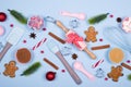 Ingredients for cooking christmas cookies, kitchen utensils, gingerbread cookies on blue pastel background. Royalty Free Stock Photo