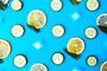 Ingredients for cooking cold spring lemonade drink with cucumber, pieces of lemon, fresh leaves mint ice cubes on blue background Royalty Free Stock Photo