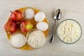 Ingredients for cottage cheese casserole with apples in plate, spoon, bowl with cottage cheese on table. Top view Royalty Free Stock Photo