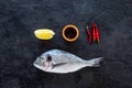 Ingredients for cooking dorado fish. Black background top view Royalty Free Stock Photo