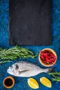 Ingredients for cooking dorado fish on blue background top view mockup