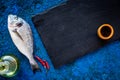 Ingredients for cooking dorado fish on blue background top view mockup