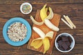 Ingredients for cooking frozen bananas in chocolate on wooden background