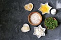 Ingredients for cooking gnocchi or dumplings with nettle on a dark gray concrete background: ricotta cheese, fresh nettle, egg, Royalty Free Stock Photo