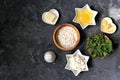 Ingredients for cooking gnocchi or dumplings with nettle on a dark gray concrete background: ricotta cheese, fresh nettle, egg, Royalty Free Stock Photo