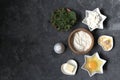 Ingredients for cooking gnocchi or dumplings with nettle on a dark gray concrete background: ricotta cheese, fresh nettle, egg, Royalty Free Stock Photo