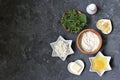 Ingredients for cooking gnocchi or dumplings with nettle on a dark gray concrete background: ricotta cheese, fresh nettle, egg, Royalty Free Stock Photo
