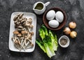 Ingredients for cooking healthy breakfast, brunch - egg, mixed mushrooms and green salad on a dark background, top view Royalty Free Stock Photo