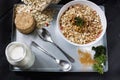 Ingredients for cooking healthy breakfast. Nuts, oat flakes, dried fruits, honey, granola, wooden heart in a white bowl. Royalty Free Stock Photo