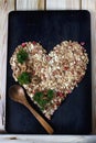 Ingredients for cooking healthy breakfast in a shape of heart. Nuts, oat flakes, dried fruits, honey, granola. Royalty Free Stock Photo