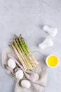 Ingredients for cooking healthy dietary breakfast . Bunch of fresh asparagus, eggs and oil. Flat lay, Royalty Free Stock Photo