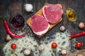 Ingredients for cooking healthy meat dinner. Raw uncooked beef rib eye steaks with mushrooms, rice, herbs and spices on table back Royalty Free Stock Photo