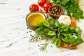 Herbs spices, olive oil and vegetables on a wooden table. Copy space Royalty Free Stock Photo