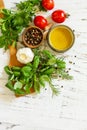 Herbs spices, olive oil and vegetables on a wooden table. Top view flat lay background. Copy space Royalty Free Stock Photo