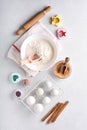 Ingredients for cooking homemade baking. Baking background with flour, eggs, kitchen tools, utensils and cookie molds on white mar Royalty Free Stock Photo