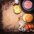 Ingredients for cooking homemade burger, tomatoes, onion rings, burger buns border ,place for text on wooden rustic background top