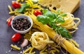 Ingredients for cooking Italian pasta - spaghetti, fusilli, fettuccine, basil, cherry tomato, garlic, pepper and cheese Royalty Free Stock Photo