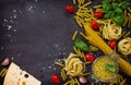 Ingredients for cooking Italian pasta - spaghetti, fusilli, fettuccine, basil, cherry tomato, garlic, pepper and cheese. Royalty Free Stock Photo