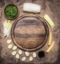 Ingredients for cooking Korean food glass noodles, chuka seaweed, boiled quail eggs, ginger, corn laid out around cutting board Royalty Free Stock Photo