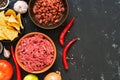 Ingredients for cooking Mexican chili con carne dishes on a black concrete background, top view. Copy space. Royalty Free Stock Photo