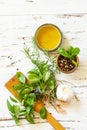 Ingredients for cooking. Olive oil, garlic and herbs on a white wooden table. Top view flat lay background. Royalty Free Stock Photo