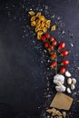 Ingredients for cooking pasta on a black background