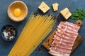 Ingredients for cooking pasta carbonara on a blue background, spaghetti, ham, egg, cheese, spices. Top view, flat lay Royalty Free Stock Photo