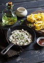 Ingredients for cooking pasta with creamy mushroom sauce - dry pasta, mushroom cream sauce, olive oil and spices. Royalty Free Stock Photo