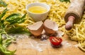 Ingredients for cooking pasta, rolling pin ,egg, herbs,wheat flour wooden background close up Royalty Free Stock Photo