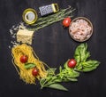 Ingredients for cooking pasta with shrimp, herbs, tomatoes, cheese lined frame place for text wooden rustic background top view