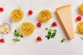 Ingredients for cooking pasta - tagliatelle, tomato, garlic, basil, parmesan cheese Royalty Free Stock Photo