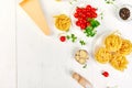 Ingredients for cooking pasta - tagliatelle, tomato, garlic, basil, parmesan cheese Royalty Free Stock Photo